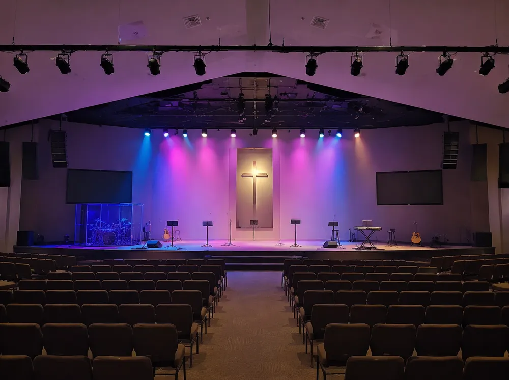 LED front wash lighting in a 300-seat church sanctuary with warm white and RGBW stage color