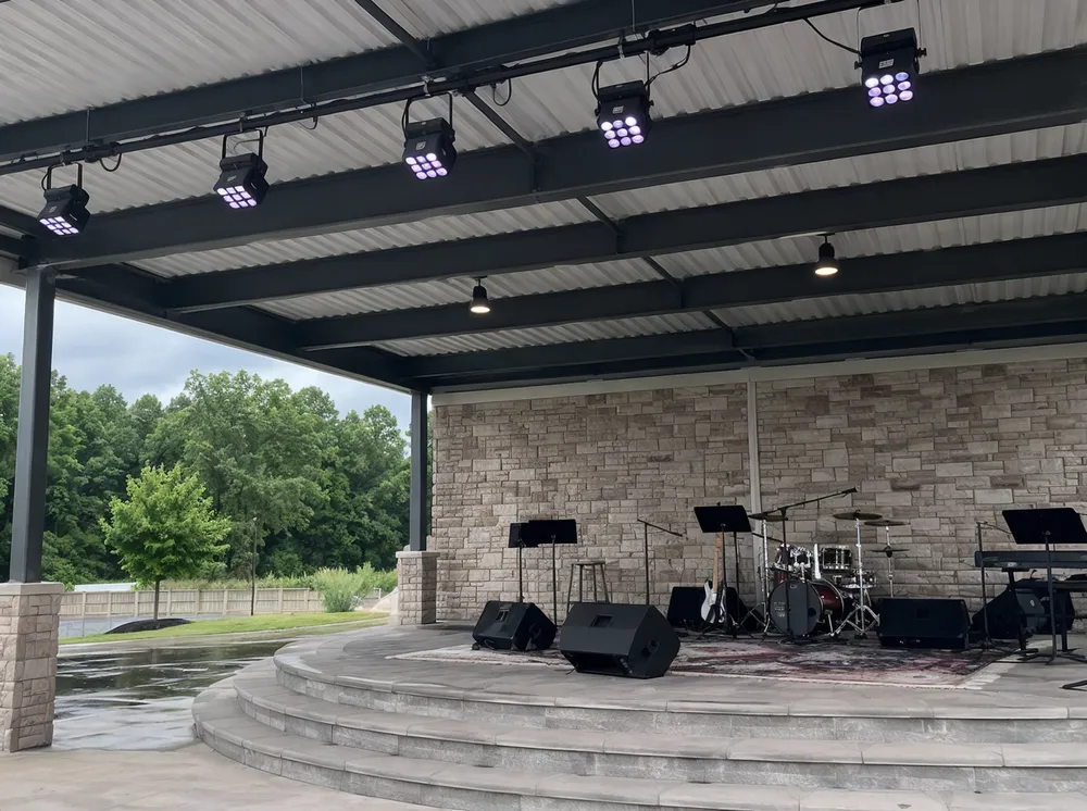 IP65 weather-rated LED church lighting fixture installed at an outdoor pavilion worship stage