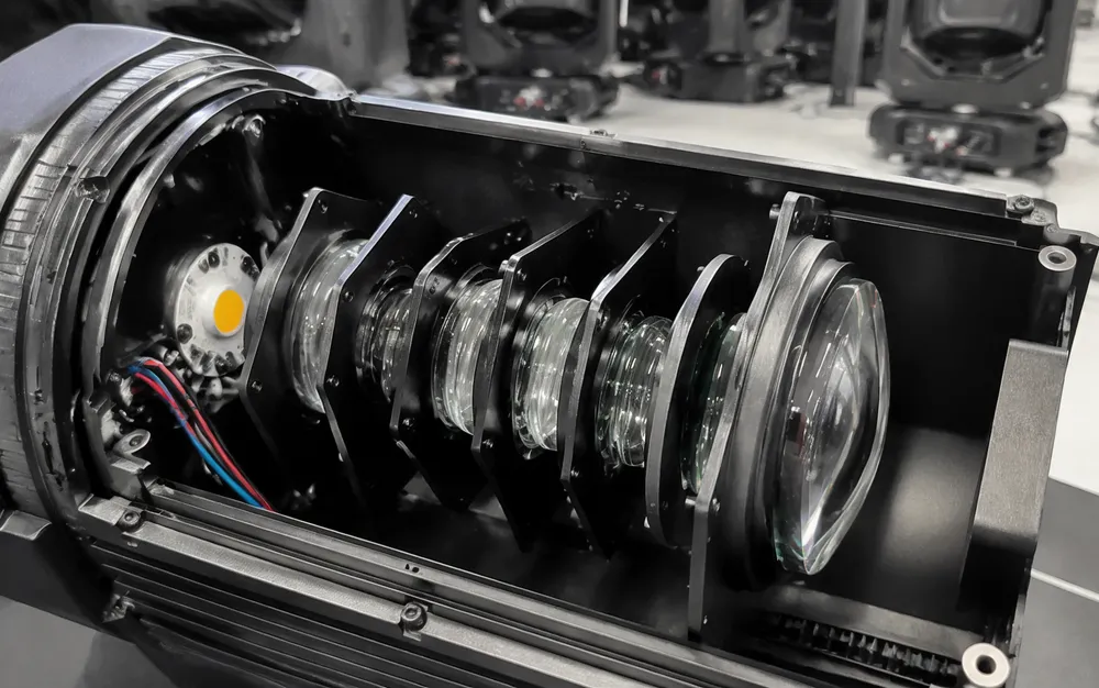 Multi-element glass lens assembly inside GDMonkey professional church stage lighting fixture showing optical path engineering