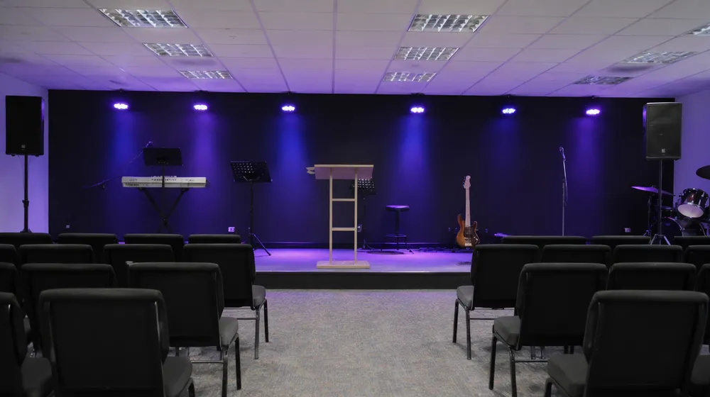 New church plant stage with LED par lighting in a rented commercial space