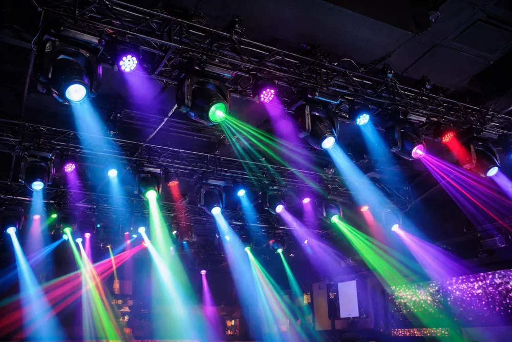 Commercial club DJ lights installed in a nightclub ceiling array with DMX-controlled beams