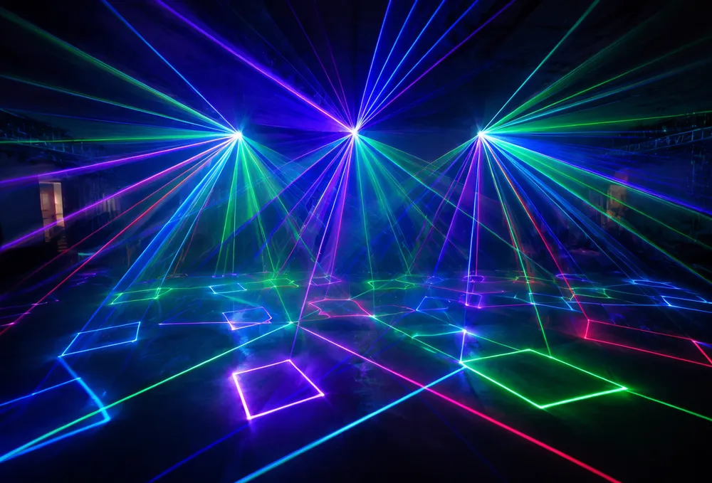 GDMonkey disco laser light fixture showing galvo-scanned beam effects in a dark venue with aerial haze patterns