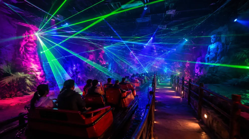 Disco laser lights creating themed ride effects and walkway ambience in an entertainment venue