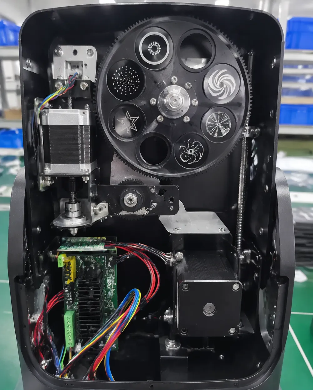 Stepper motor precision assembly inside a DMX disco DJ light fixture showing microstepping driver and gobo wheel mechanism