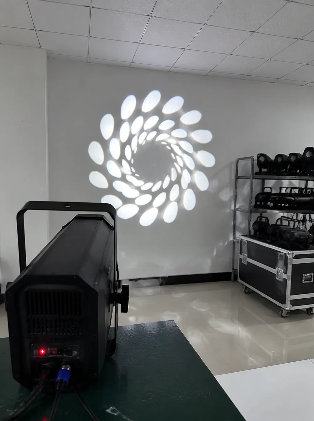 Gobo disco DJ light projecting patterns onto a venue wall — GDMonkey manufacturing facility output