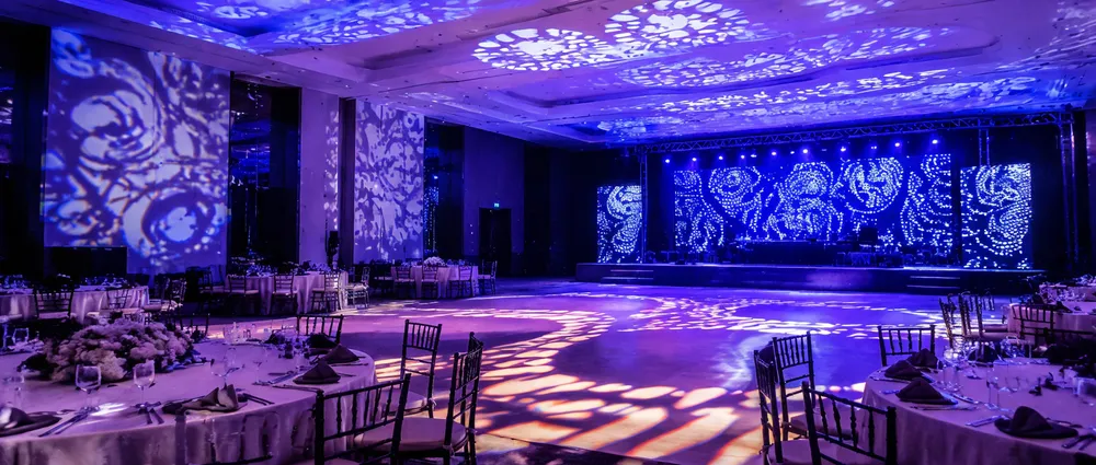 Gobo patterns projected across a venue interior — branded imagery on walls and ceiling from GDMonkey fixtures