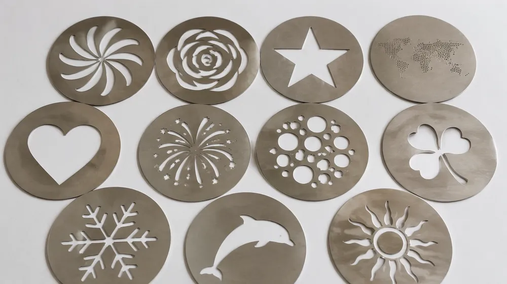 Stamped stainless steel metal gobos showing text and logo silhouette patterns
