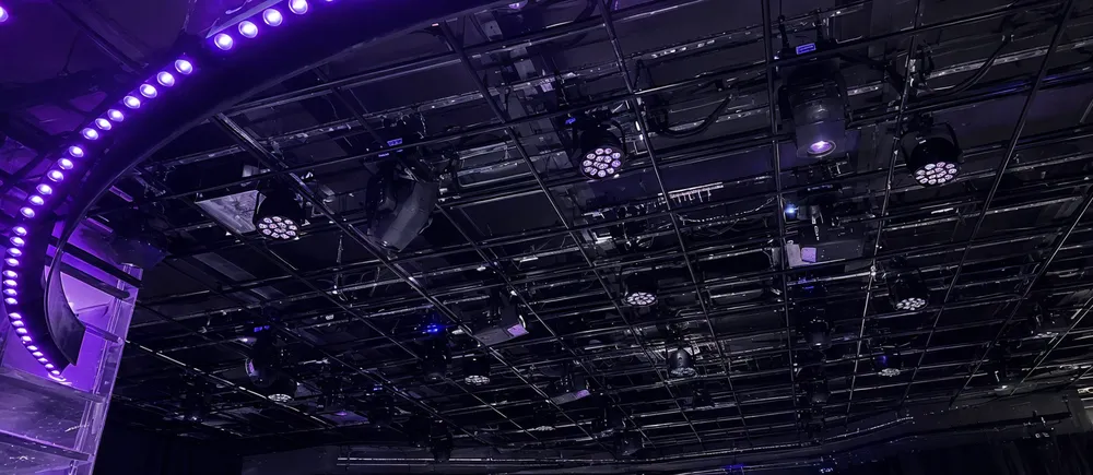Permanent DMX disco DJ light installation in nightclub ceiling grid