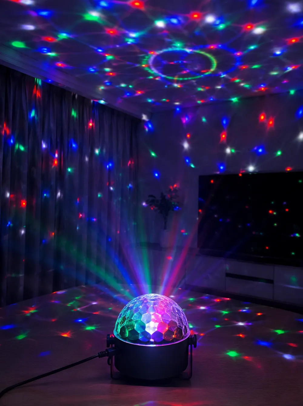LED disco DJ light fixture showing multi-color beam projections in a room setting
