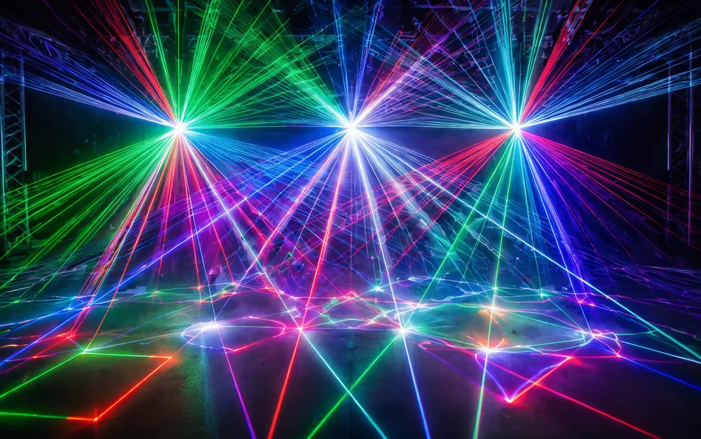 RGB laser projector DJ light showing full-color wide-gamut beam patterns