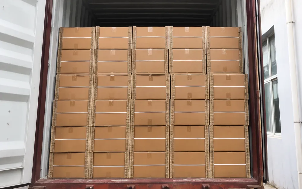 Master cartons of professional DJ laser lights stacked for container loading with corrugated corner protection