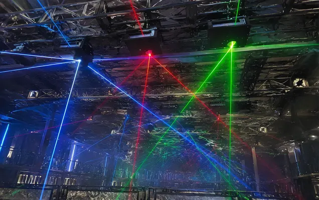 RGB laser projectors installed on truss in nightclub ceiling array