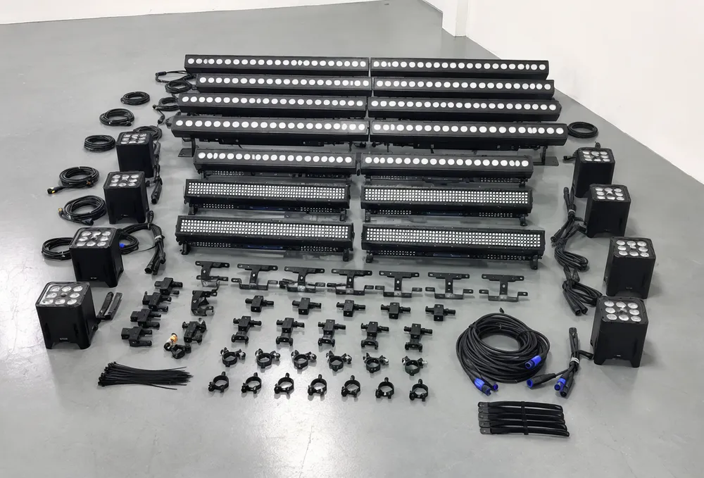 Complete DJ booth lights setup kit showing LED wash bars, pixel strips, and compact effect lights arranged for facade mounting