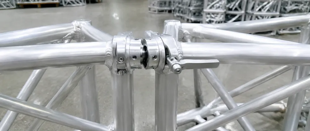 Detail view of conical coupler connection system on aluminum DJ lighting truss showing half-turn locking mechanism