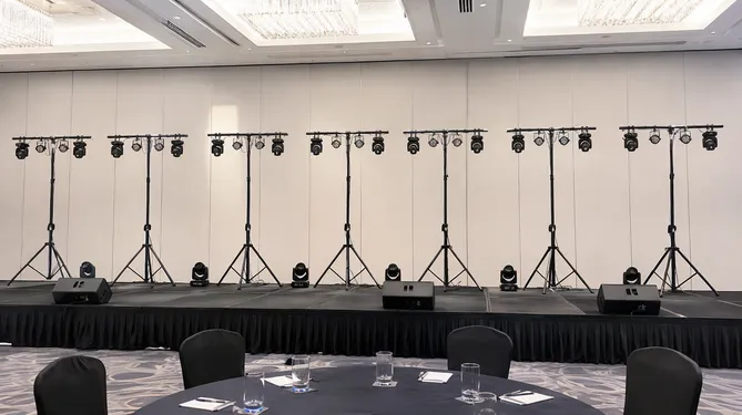 Corporate event stage with multiple aligned T bar stands for consistent fixture positioning