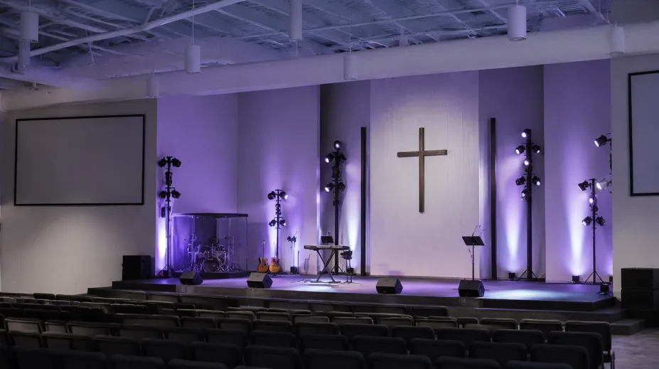 Stage lights stands installed in a modern worship space with LED wash and profile spots