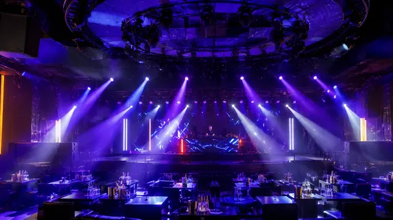 Stage lighting installation in a nightclub venue with moving heads and wash fixtures