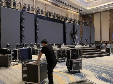 Event production company deploying LED fixtures for corporate stage setup