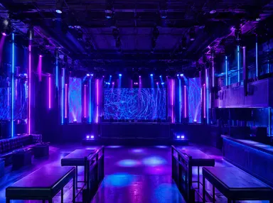 Nightclub interior with fixed-install LED lighting system showing coordinated color wash