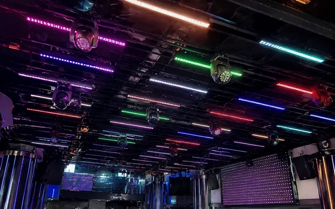 LED pixel bar array installed across nightclub ceiling grid with Art-Net controller