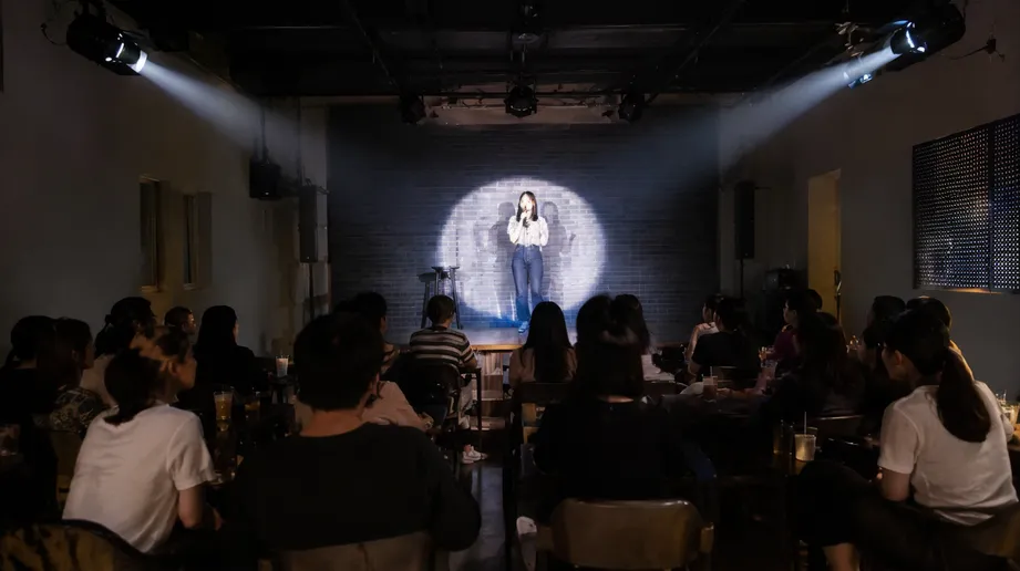 LED DJ spotlight providing focused beam on performer at a small bar venue stage