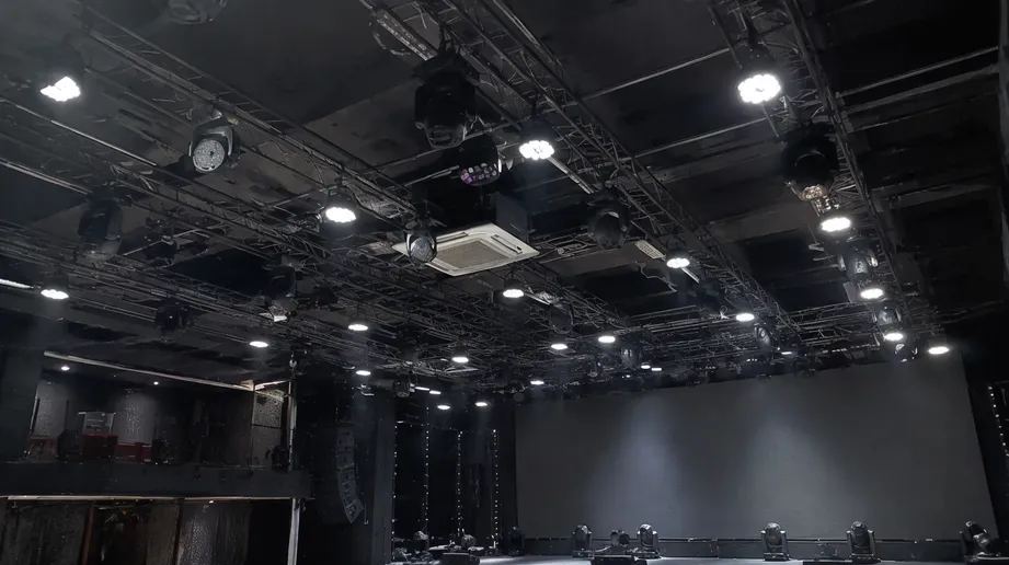 Permanent LED stage light installation in concert venue with fixed truss rig