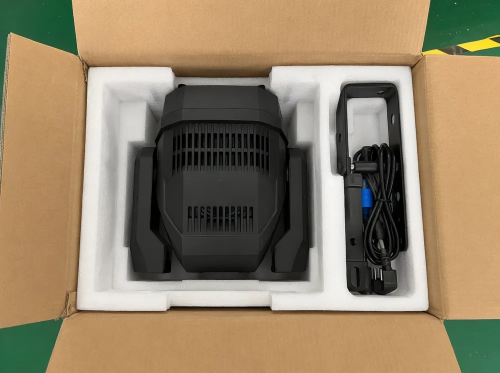 Custom-molded high-density foam packaging for LED DJ stage light with separated compartments for fixture body, yoke bracket, and power cable