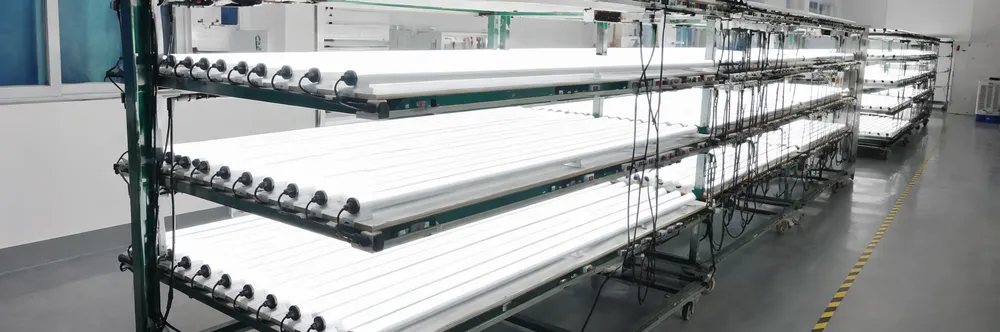 LED DJ tube lights running 48-hour aging test on production rack with full white output