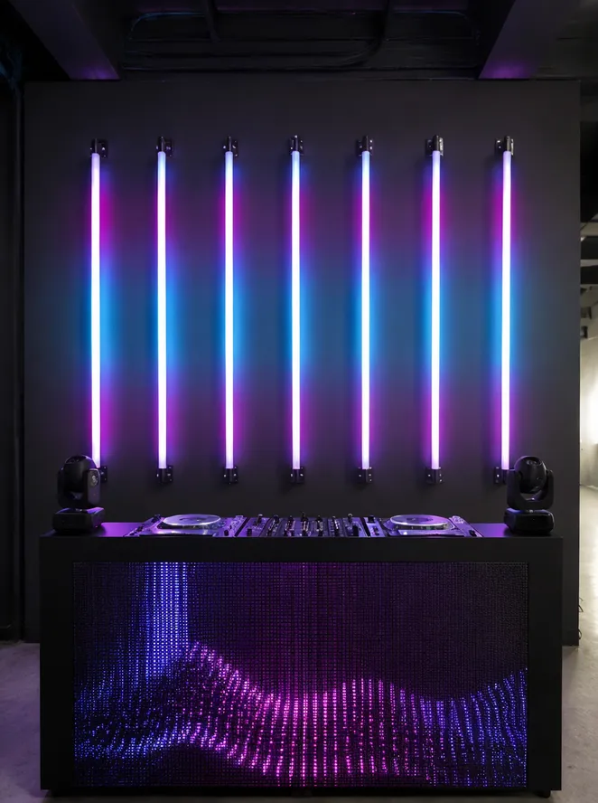 Eight LED DJ tube lights mounted vertically creating a light wall behind DJ booth