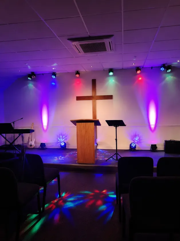 Mini LED DJ lights used as budget-friendly stage effects in a community worship space