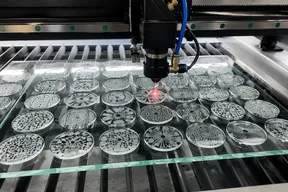 Laser-cut custom glass gobo being produced for beam fixture brand projection