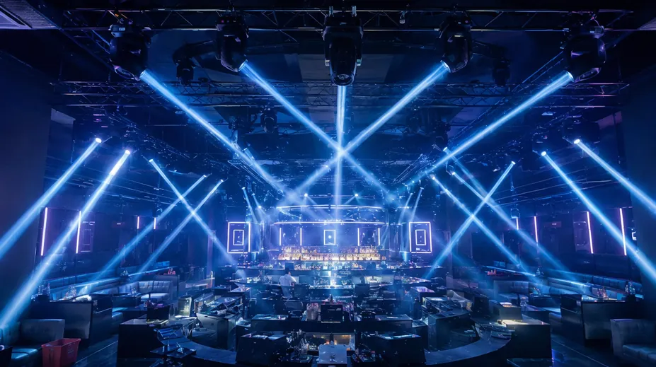 Beam moving DJ lights installed in a nightclub ceiling rig with multiple fixtures creating aerial effects