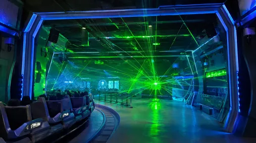 Laser effects integrated into theme park ride experience with permanent installation fixtures
