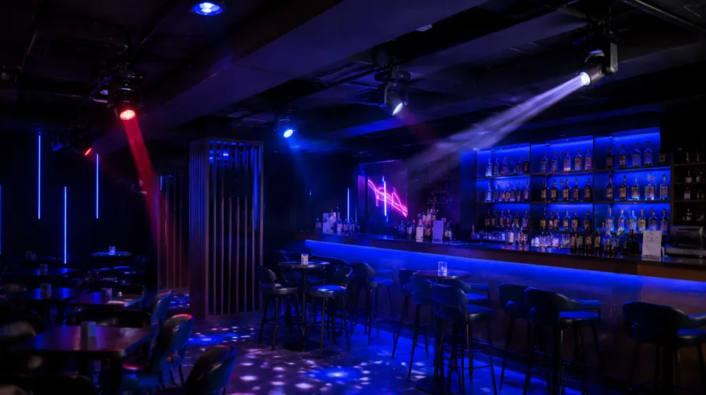Mini moving head lights ceiling-mounted in a bar venue running on auto mode