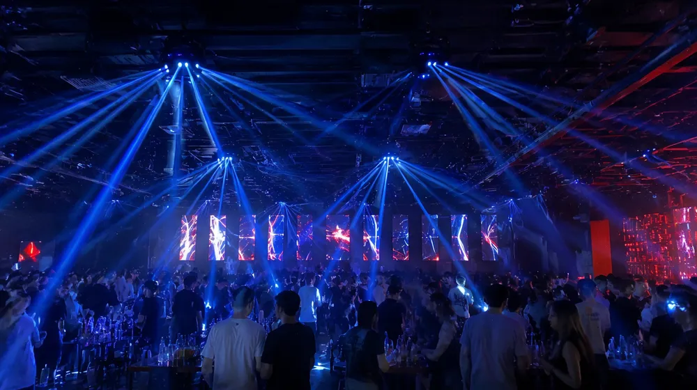 Spider moving lights installed on nightclub ceiling covering dance floor