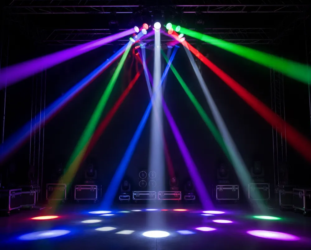 Spider moving DJ light with 8 independently controlled RGBW heads producing geometric beam patterns on stage