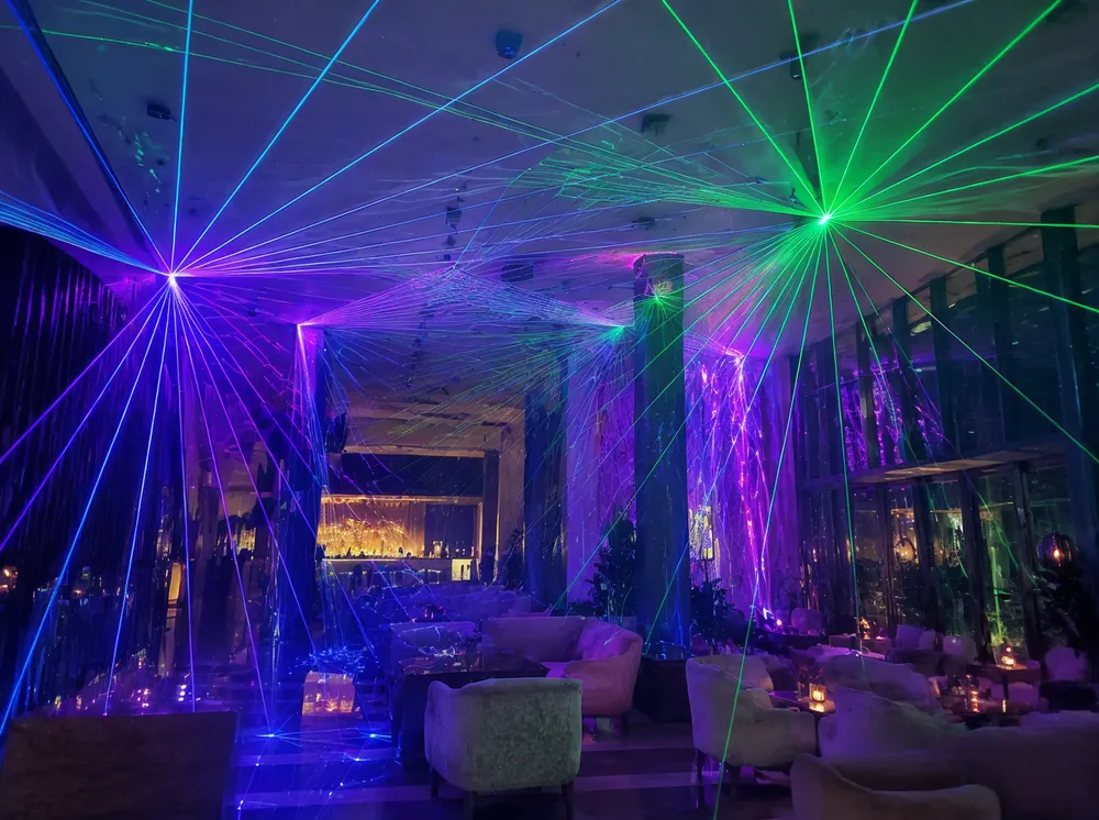 Laser projection creating ambient atmosphere in a hotel entertainment zone