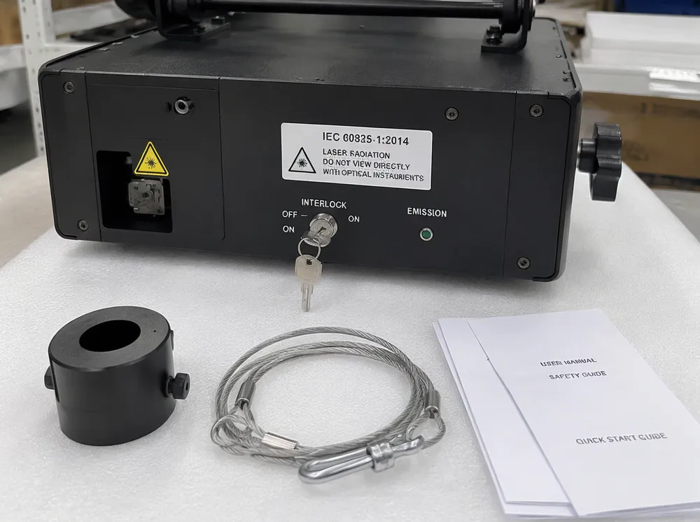 Laser safety compliance documentation including IEC 60825-1 classification label, interlock key switch, and emission indicator on laser projector unit
