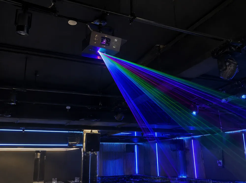 Ceiling-mounted laser projector in a nightclub permanent installation