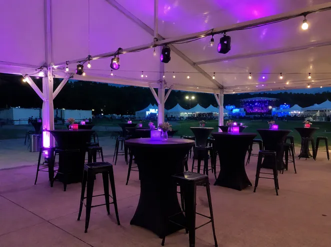 Wireless DJ lights deployed in outdoor tent event at festival with battery operation and IP44 splash protection