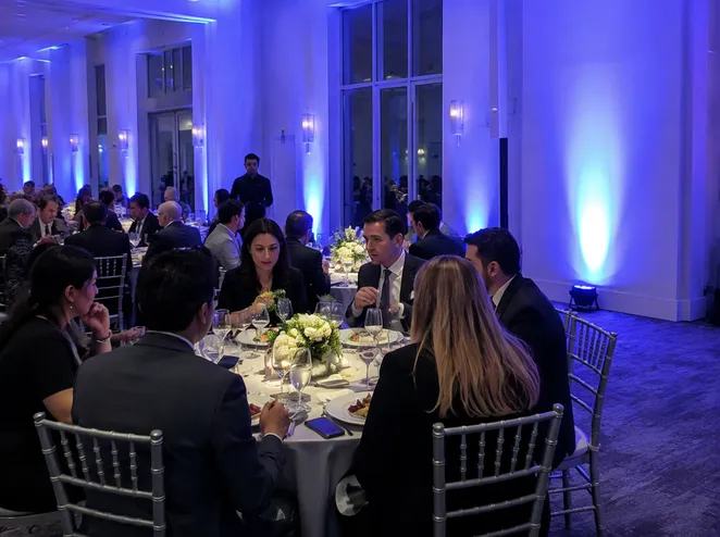 Wireless DJ uplights deployed at corporate event reception with cable-free table wash lighting