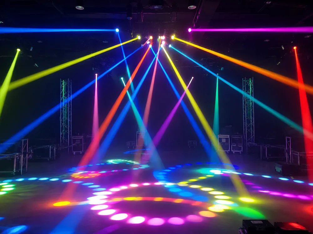 Animated DJ lights multi-beam array producing geometric sweep patterns on stage