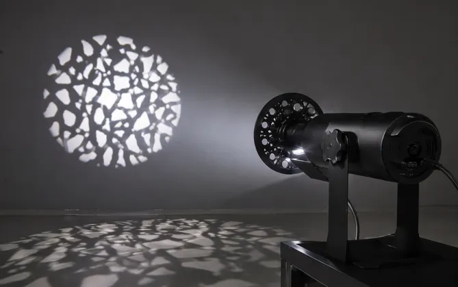 Gobo projector fixture with rotating gobo wheel producing sharp breakup patterns