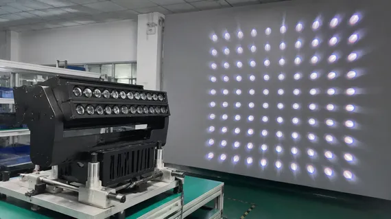 Fixture-jigged lens plate on a 64-beam DJ effect light undergoing beam geometry verification on a projection wall