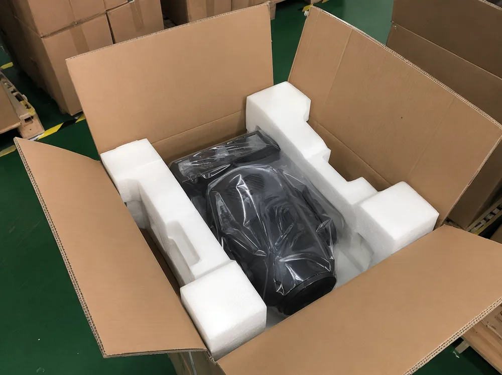 Reinforced packaging with molded foam inserts designed for container transport of professional DJ lighting fixtures
