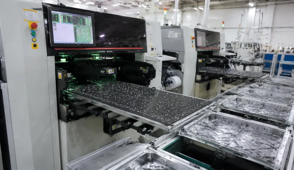 GDMonkey automated SMT production line placing LED chips on backdrop panel PCBs with die-cast aluminum frames visible on assembly conveyor