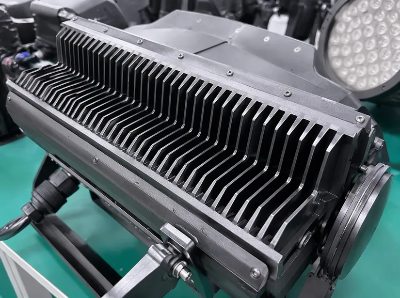 CNC-machined aluminum heatsink fins on LED stage lighting fixture showing thermal management engineering