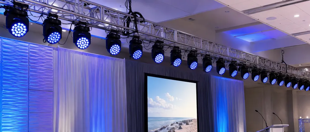 Matched fleet of LED wash par fixtures deployed on truss rigging for corporate event production