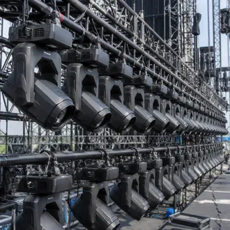 Fleet of matching beam moving heads rigged for touring production