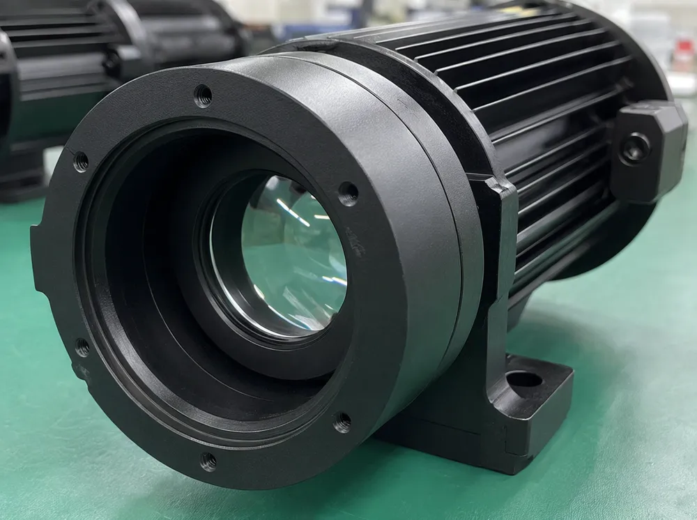 DJ spotlight optical system with single-element plano-convex lens in machined housing bore